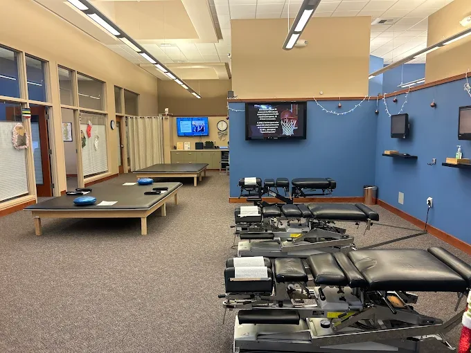 The open treatment floor at APS with adjusting tables and exercise equipment